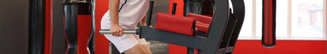 A man exercising on a dip station at home.