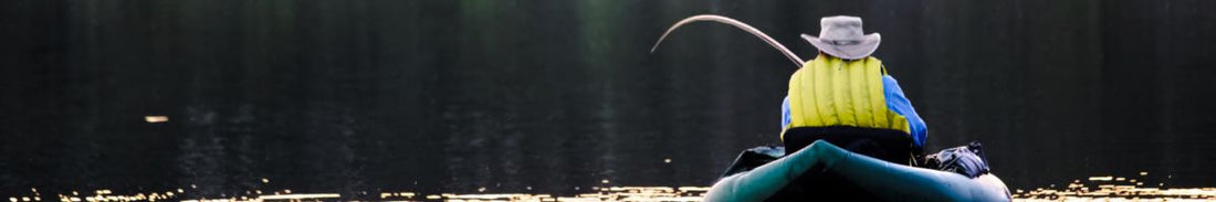 A fisherman fishing in an inflatable fishing kayak.