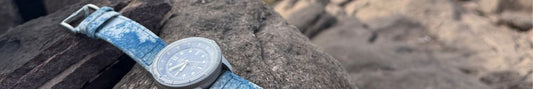 A VERO Tide tracker watch on a rock.